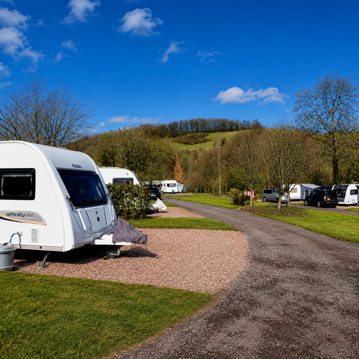 Fully serviced caravan pitch bollard with electric hook-up water tap and waste drainage area