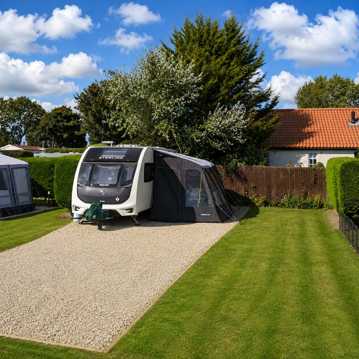 Peaceful UK caravan pitch with awning setup on a serviced touring pitch