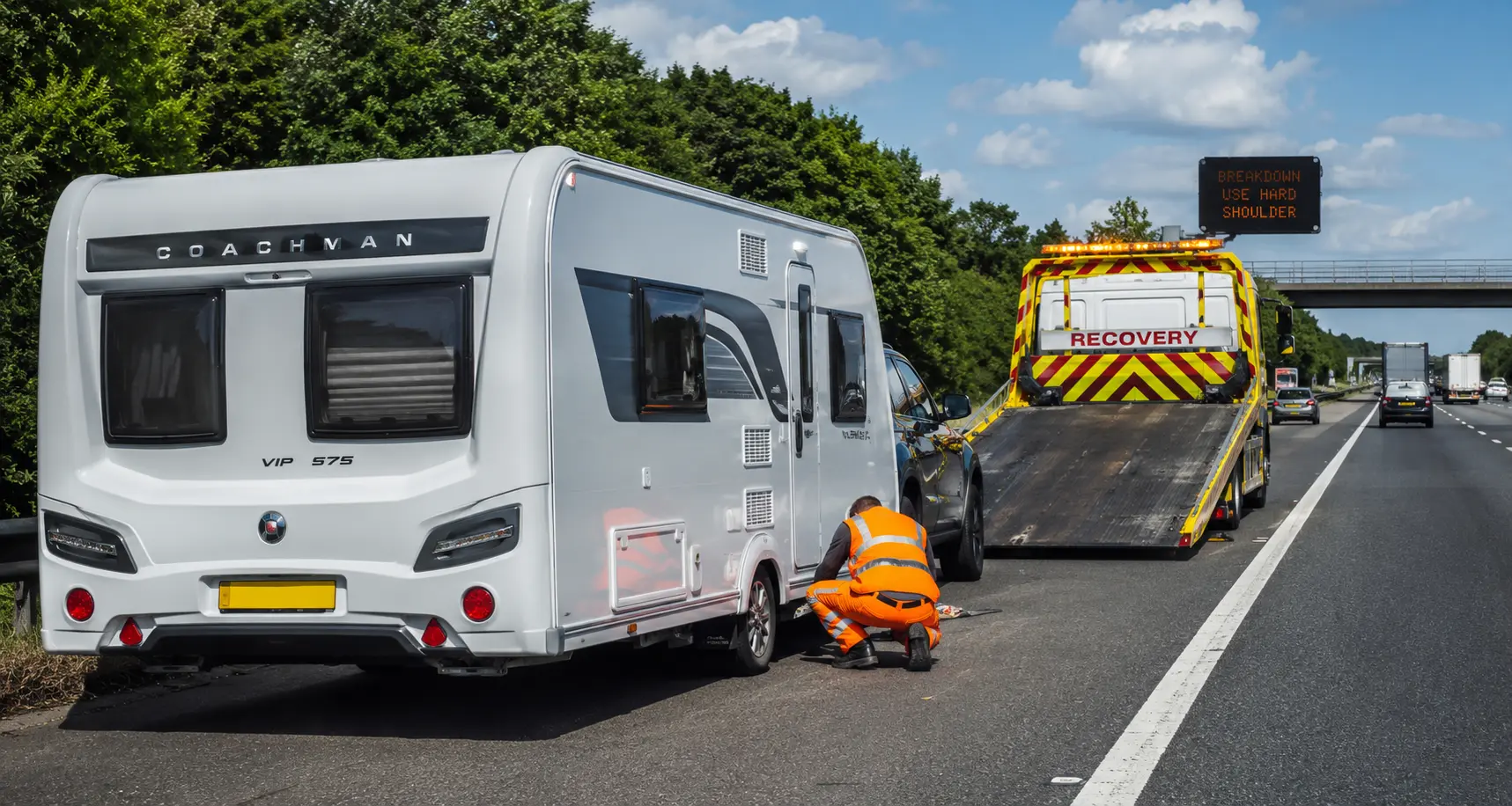 Recovery vehicle assisting a touring caravan on a UK roadside