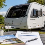 UK touring caravan with insurance documents on campsite table