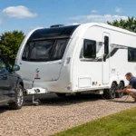 Owner carrying out essential caravan safety checks before towing in the UK
