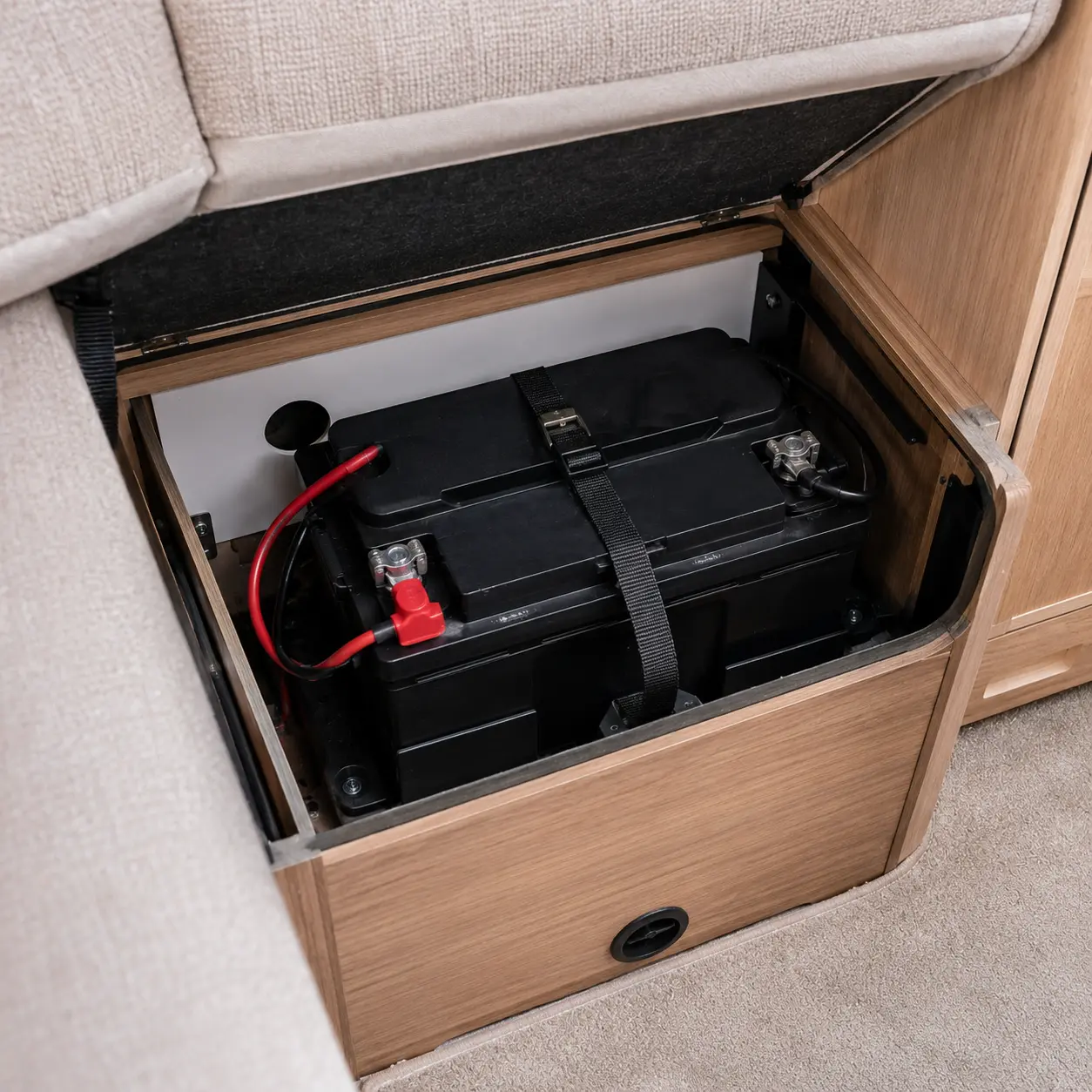 Leisure battery installed beneath seating inside a British touring caravan