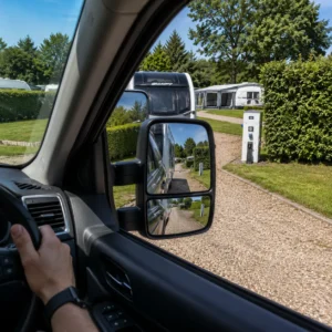 Driver checking towing mirrors during caravan reversing