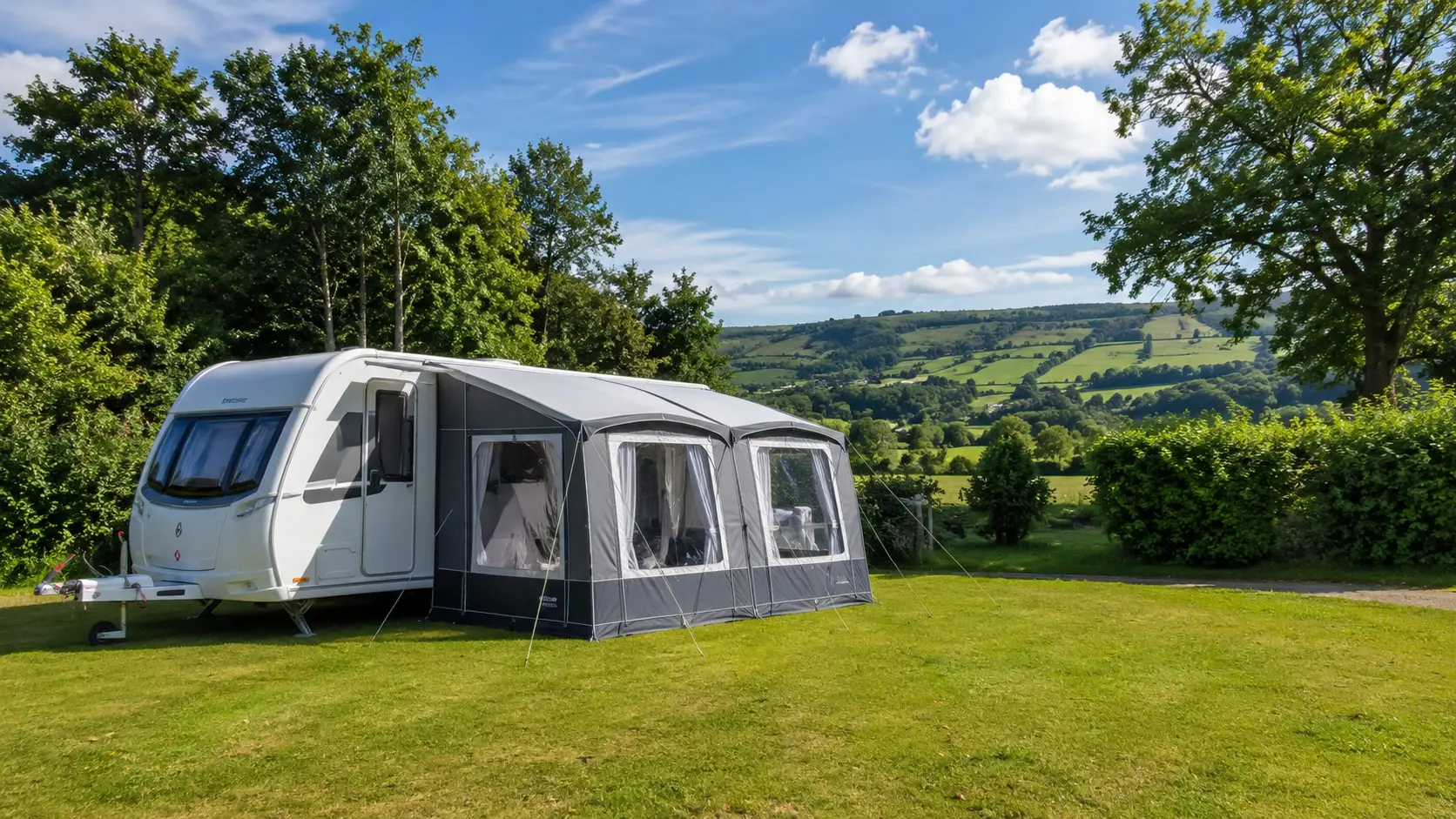 Modern UK touring caravan on a spacious countryside campsite showing affordable caravan touring