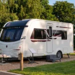 Starlink Mini set up beside a white Coachman Sussex Singleton caravan on a UK campsite
