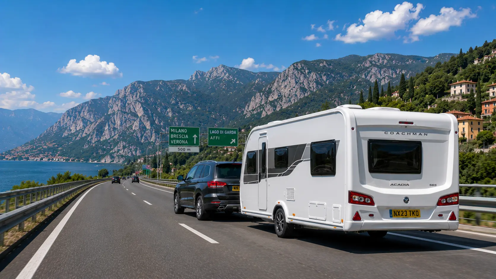 British SUV towing a modern UK touring caravan along an Italian motorway with mountains in the background