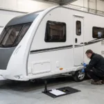 Technician carrying out an annual service on a modern UK touring caravan