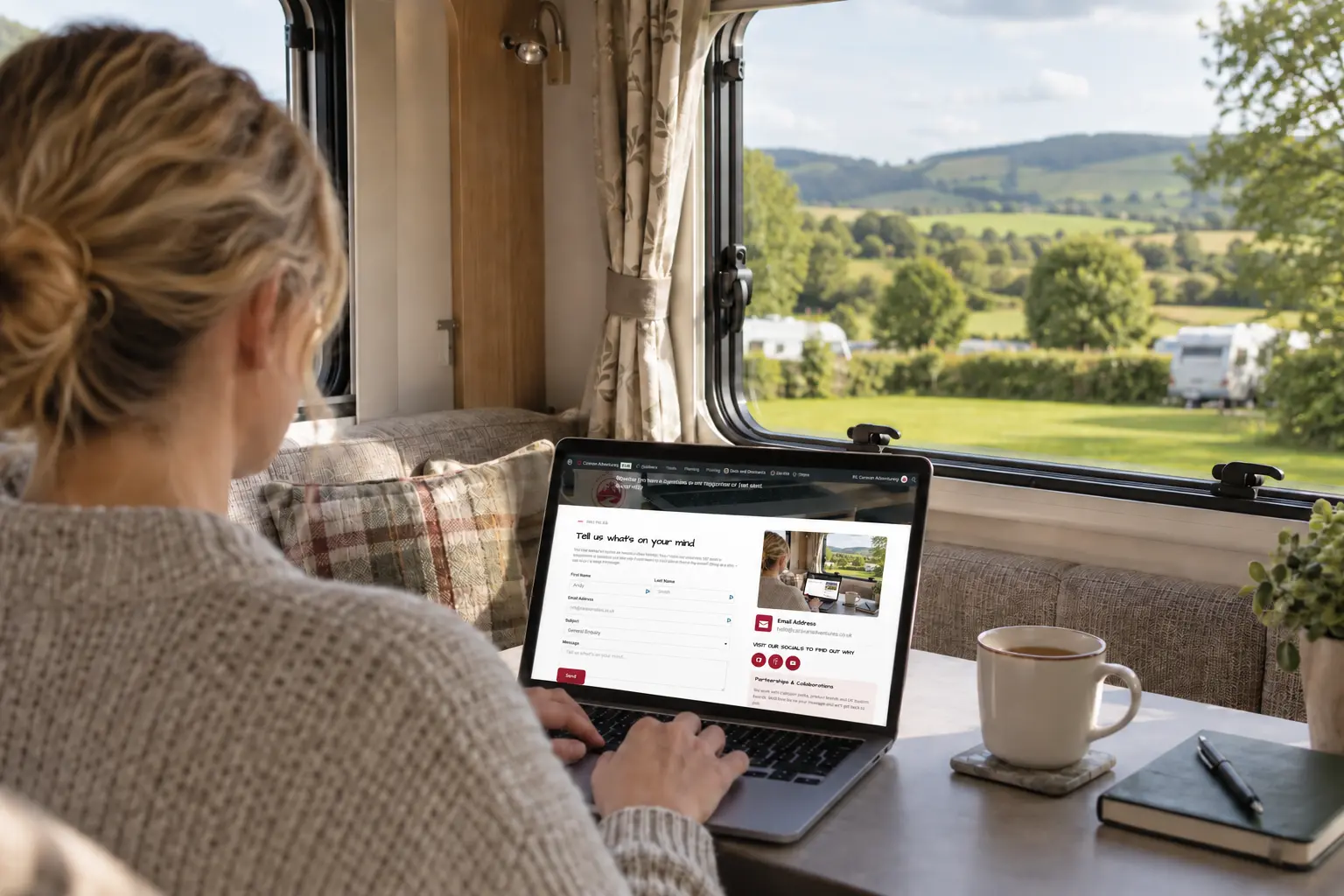 Person using the Caravan Adventuring contact page on a laptop inside a caravan